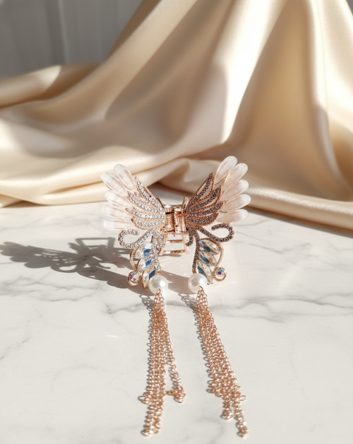 Decorative brooch with butterfly design and tassels on a fabric background